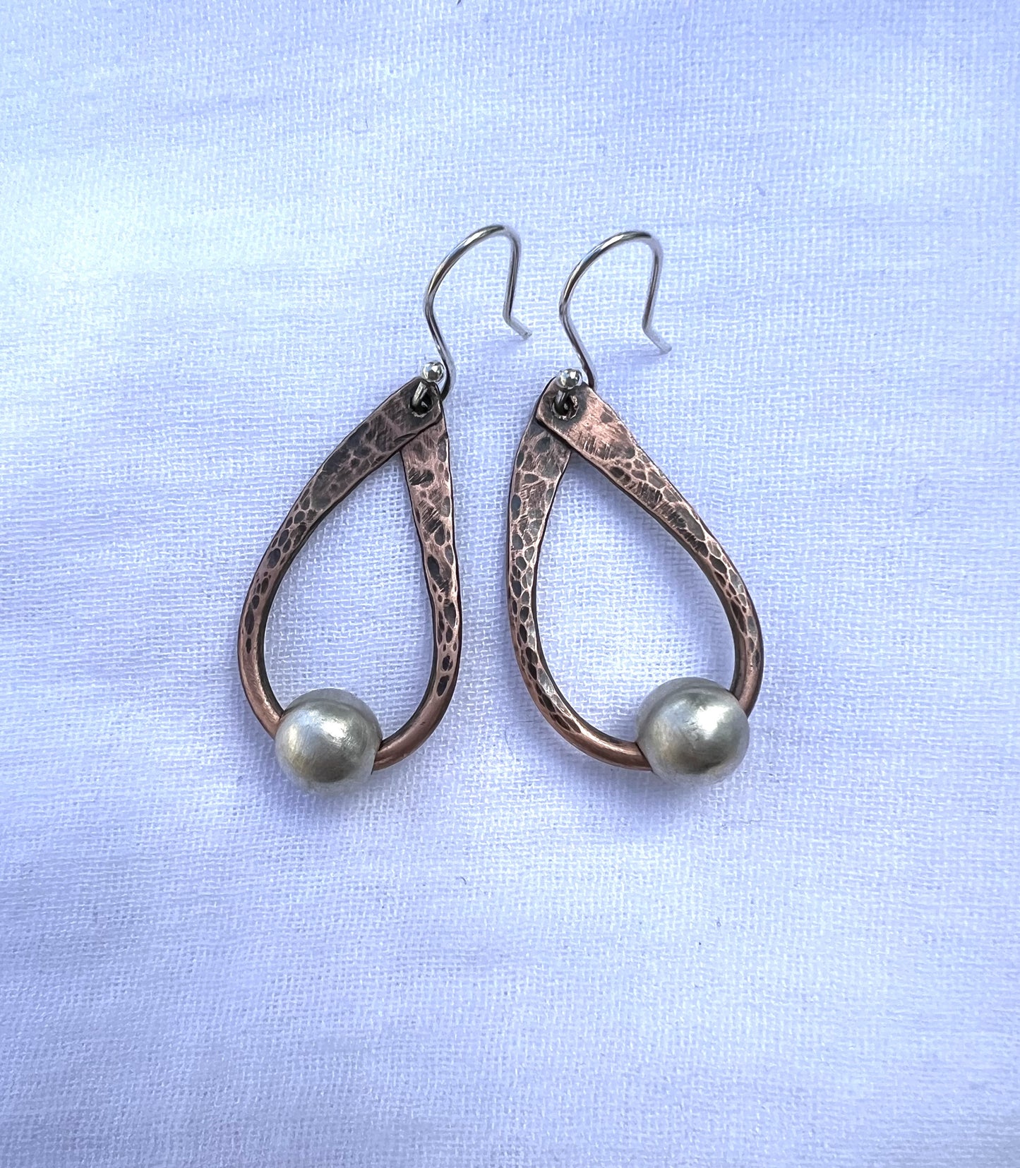 Hand hammered teardrop copper earrings with sterling silver bead